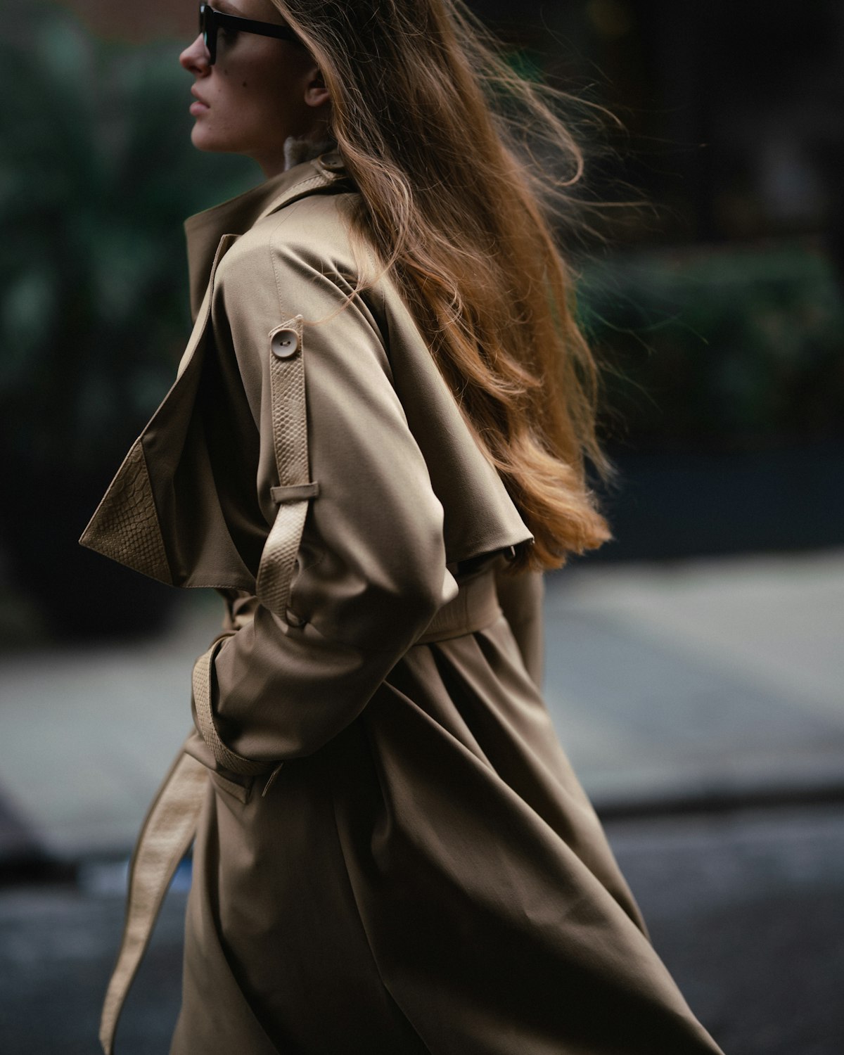 Trench coat in motion on a moody autumn street
